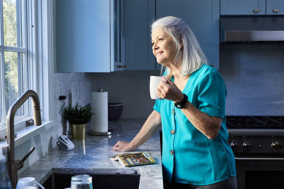 Woman calmly drinking coffee at sink