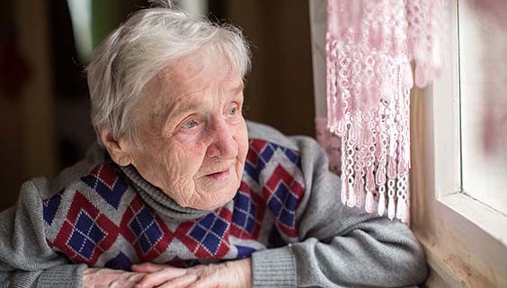 Senior woman staring out window