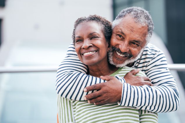 Black senior couple hugging