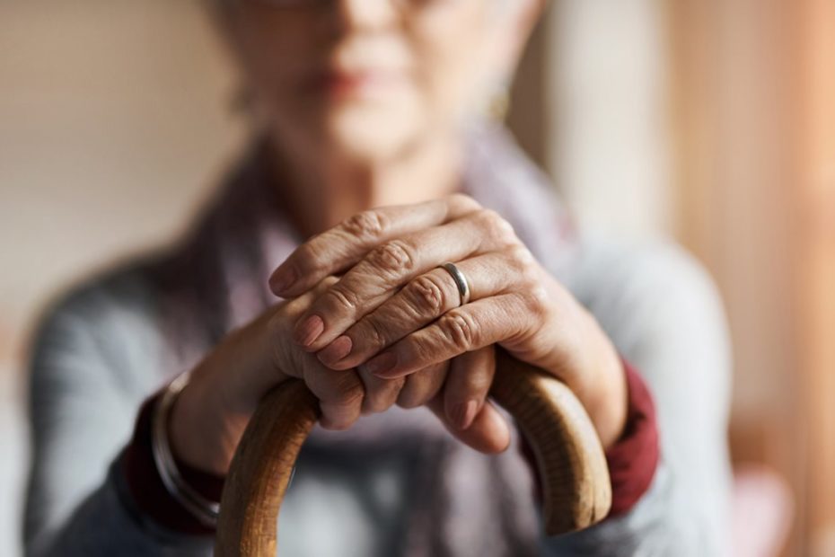 Senior lady leaning on cane