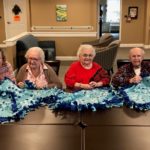 Senior ladies sewing together