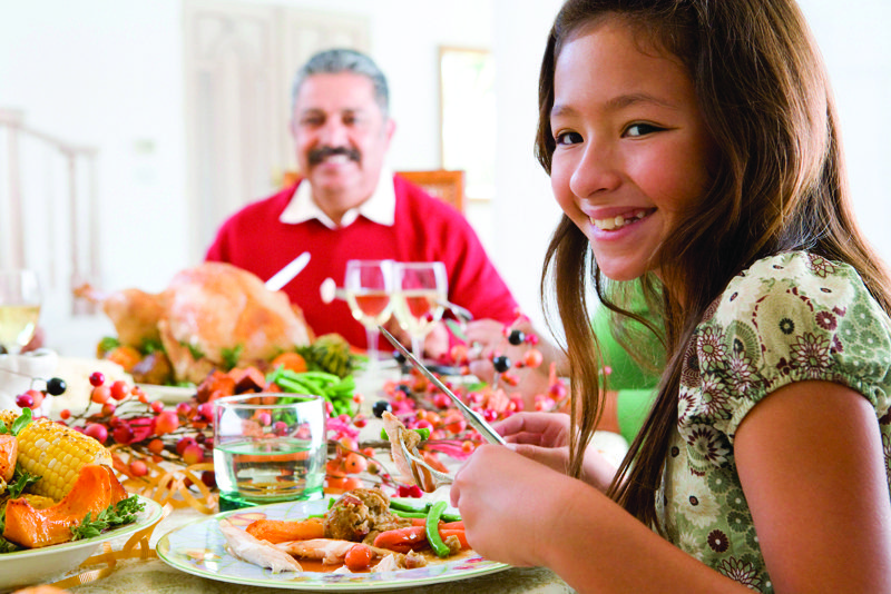 Young girl eating with grandpa