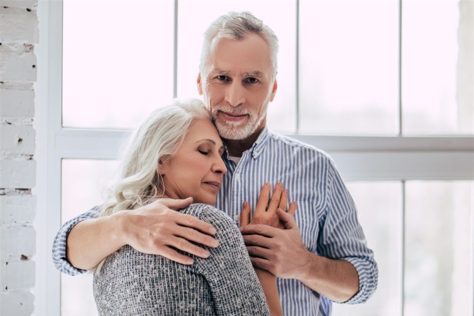 Senior man comforting senior woman with a hug