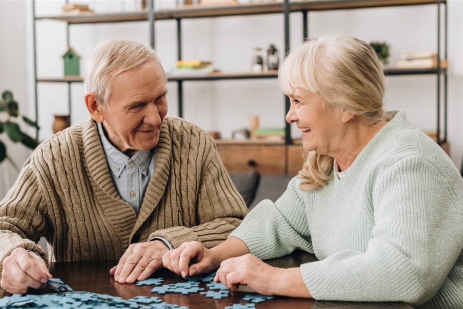 Elderly couple with jigsaw puzzle