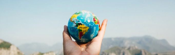 Hand holding small globe