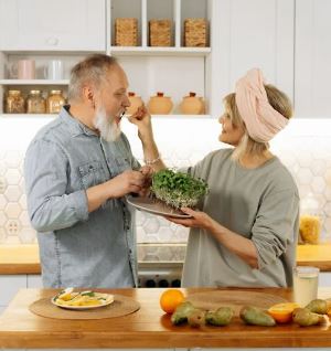 Senior wife feeding husbanc