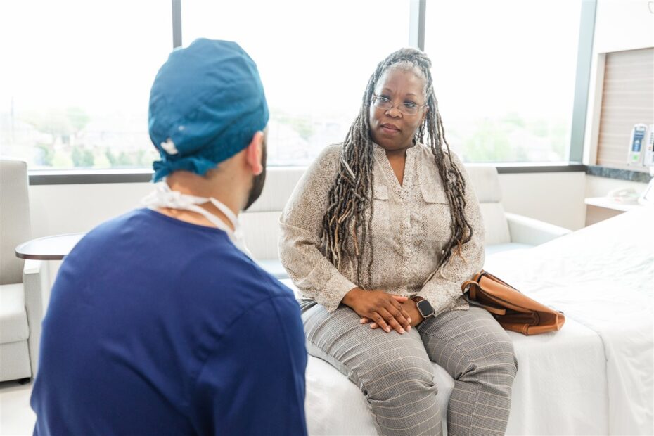 Female patient on hospital bed consulting physician