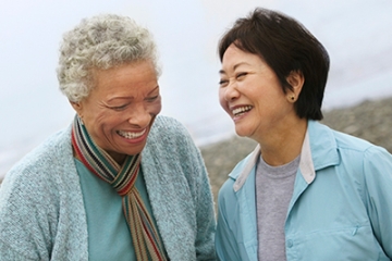 Two women share a laugh outdoors