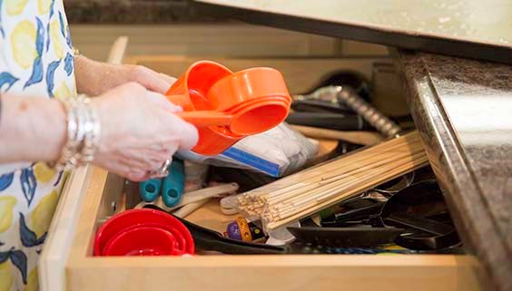 Older woman rummaging through a drawer