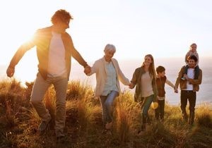 Family walking together in a sunny field