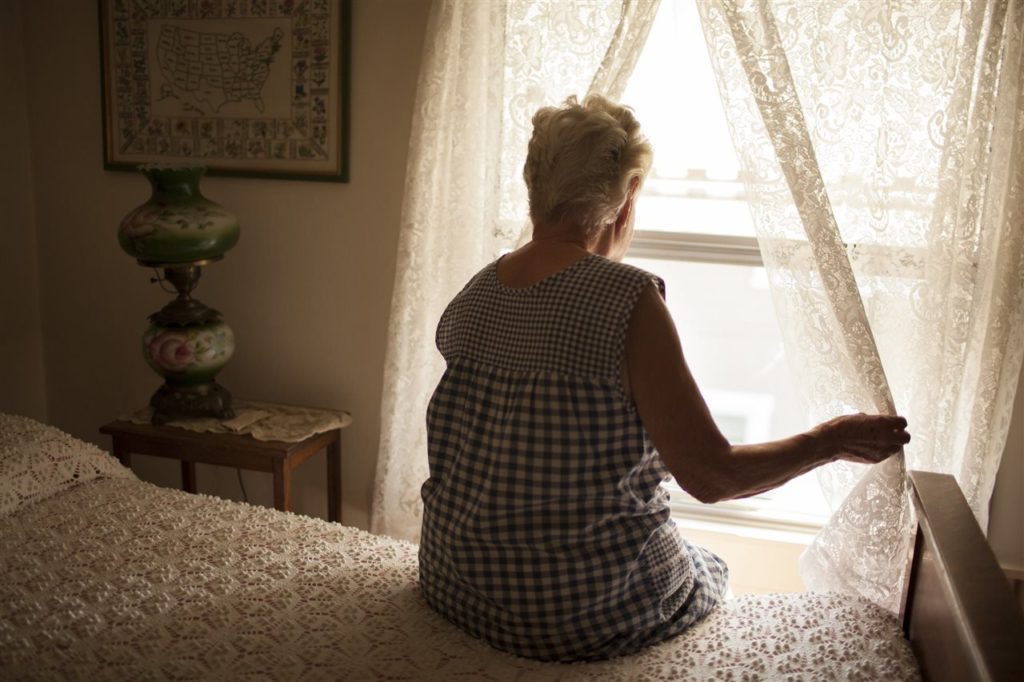 Lonely woman looking out window