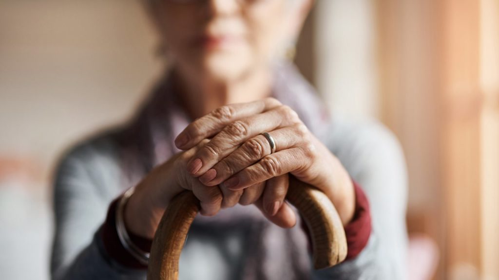 Senior lady leaning on cane