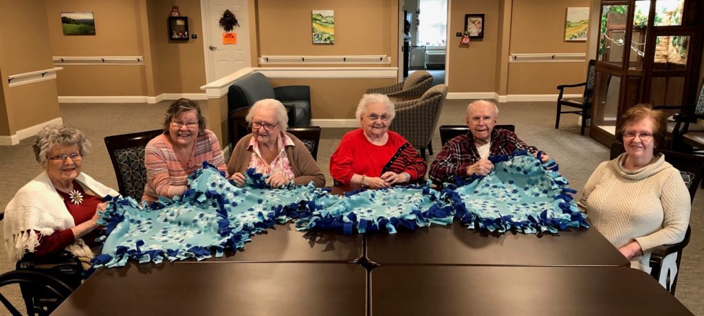 Senior ladies sewing together