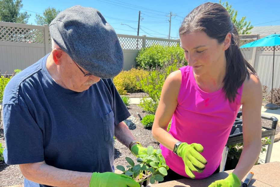 Resident and aide gardening