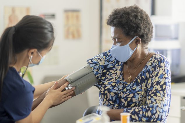 Senior woman blood pressure check