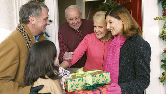 Family visiting seniors with presents