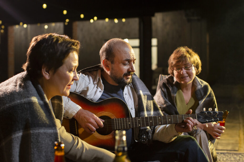 Man playing guitar in singing trio