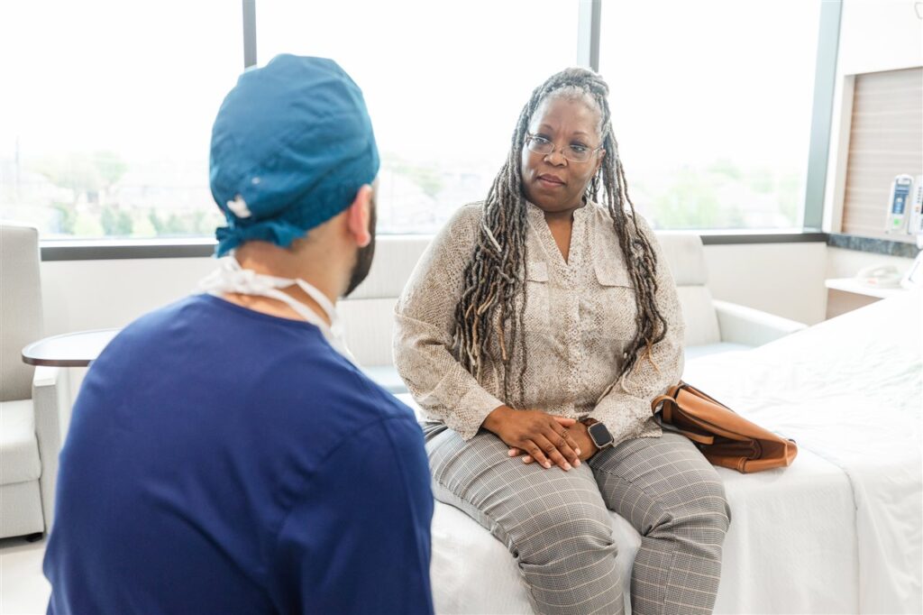 Female patient on hospital bed consulting physician