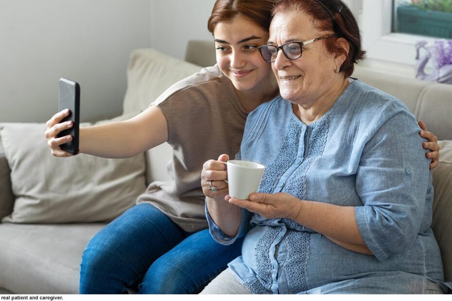 Senior woman and caregiver using phone app