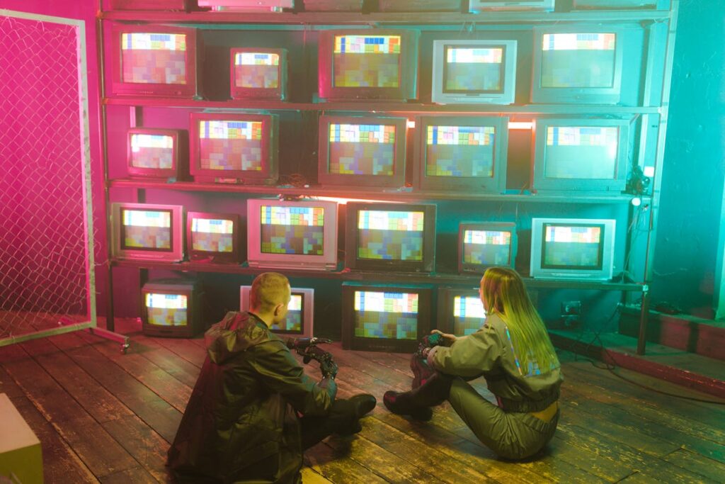 Young couple watching multiple TV screens