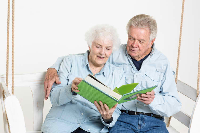 Seniors looking through scrapbook