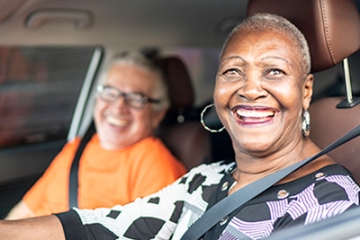 Senior women smiling and driving
