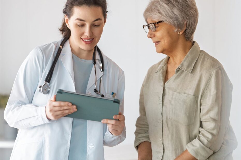 Senior woman consulting with nurse (BP)